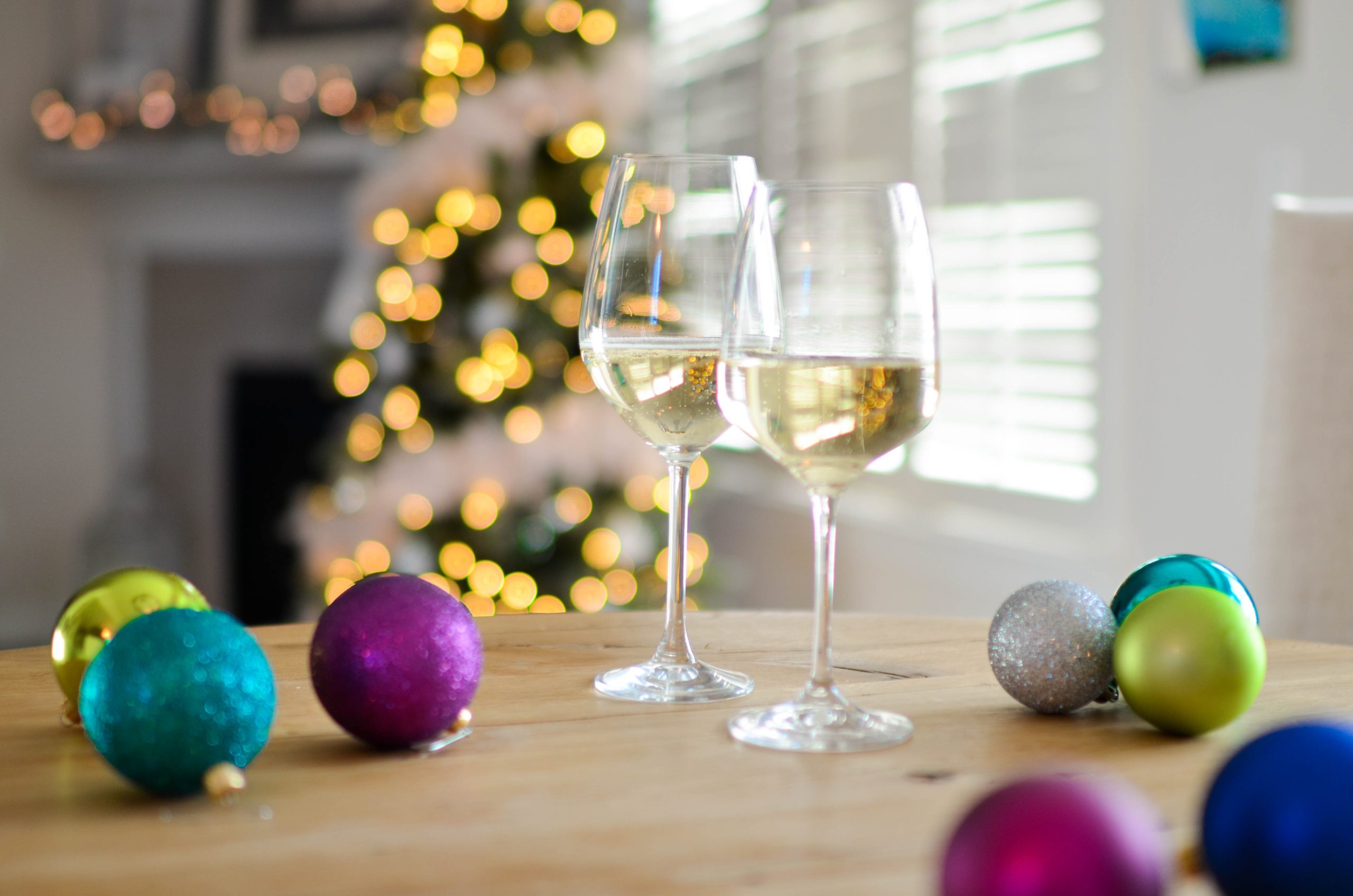Savor the holidays in Currituck County Glasses of wine on table with holiday decorations